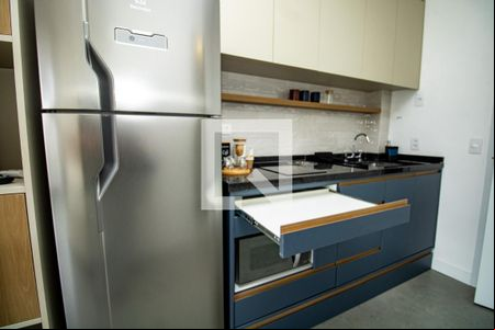 Cozinha, geladeira, bancada de armários com prateleiras móveis  de kitnet/studio à venda com 1 quarto, 25m² em Moema, São Paulo